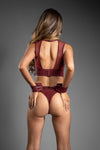 Burgundy faux leather cut-out lingerie set with crotchless panty, gold hardware, and cuffs.