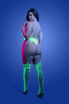 Plus Size Back view: Neon green UV glow halter teddy bodystocking with thong back and garter-style straps, model posing from behind.