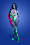 Plus Size Front view: Neon green UV reactive halter teddy bodystocking with fishnet cutouts and attached stockings, model standing against blue background.
