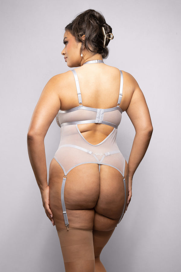 Silver embroidered mesh bustier with rhinestone harness detail and adjustable garter straps, blending glamour and bold sophistication