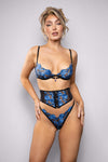 Sapphire blue embroidered bra set with sheer waspie and matching g-string in delicate mesh, adorned with jewel accents for an elegant, seductive finish.