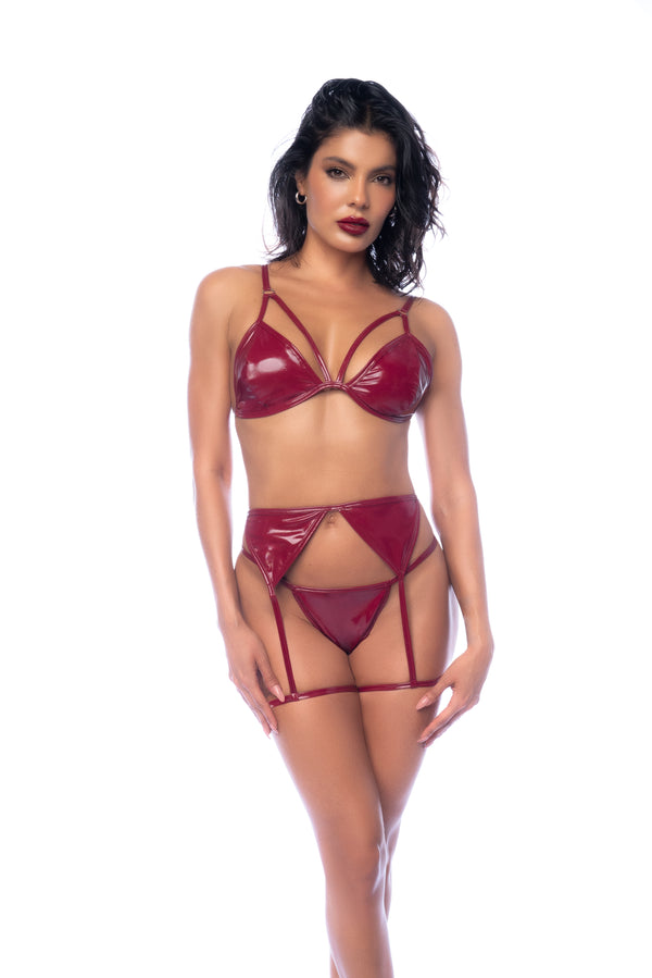 A bold vinyl three-piece lingerie set featuring a glossy bralette, adjustable straps, matching garter belt, and thong in a timeless yet edgy design.