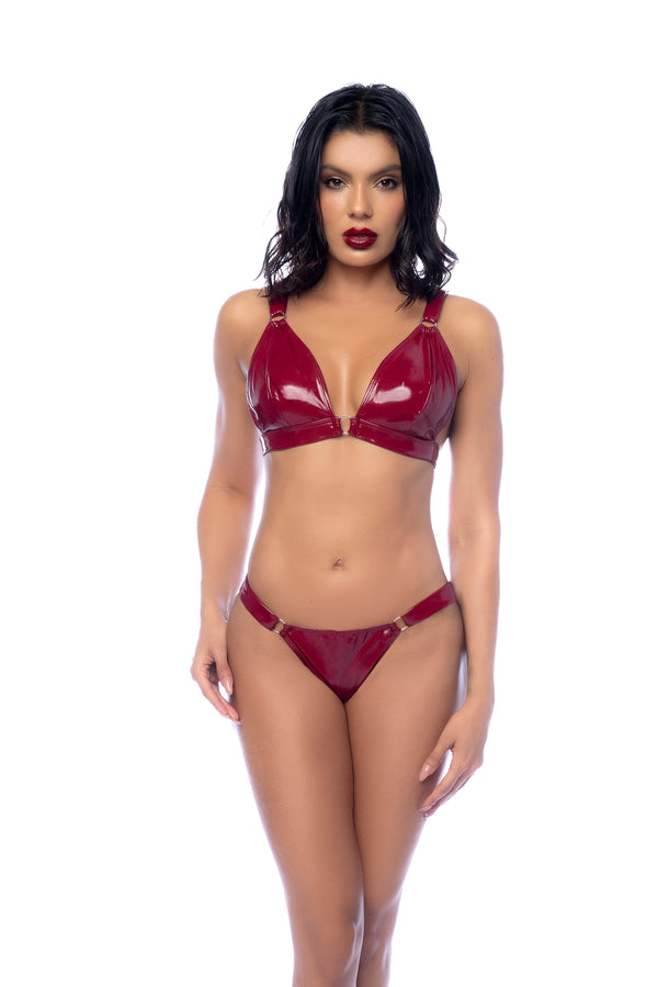 A striking two-piece vinyl lingerie set in an iconic color, featuring a bralette with ring details and a matching thong.