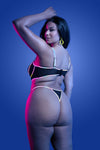 Black reflective lingerie set with underwire bra and strappy panty, featuring multicolor glow binding and sheer mesh panels.