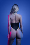 Black halter teddy with sheer mesh and rainbow reflective binding, featuring high-cut legs and thong back that glows under light.